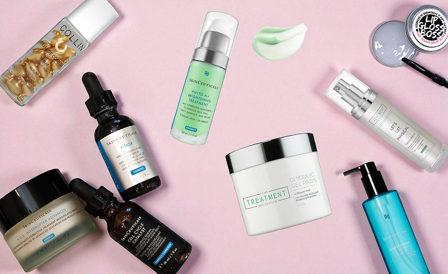 Collection of skincare products on a pink background